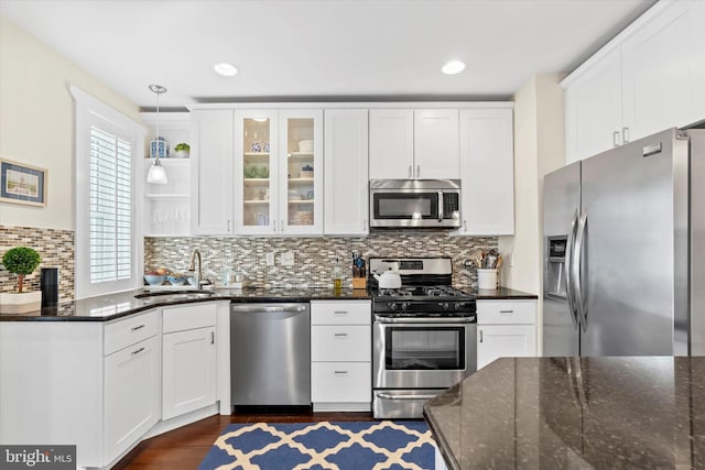 kitchen with a sink, appliances with stainless steel finishes, and white cabinets