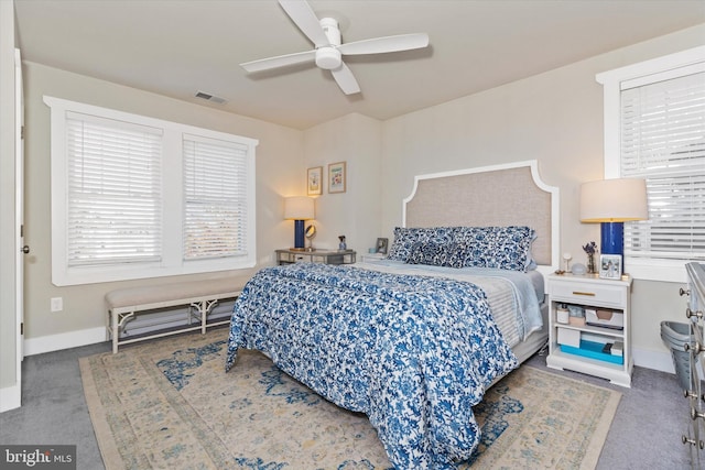 bedroom with visible vents, baseboards, carpet, and a ceiling fan