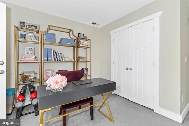 office area featuring visible vents and carpet flooring