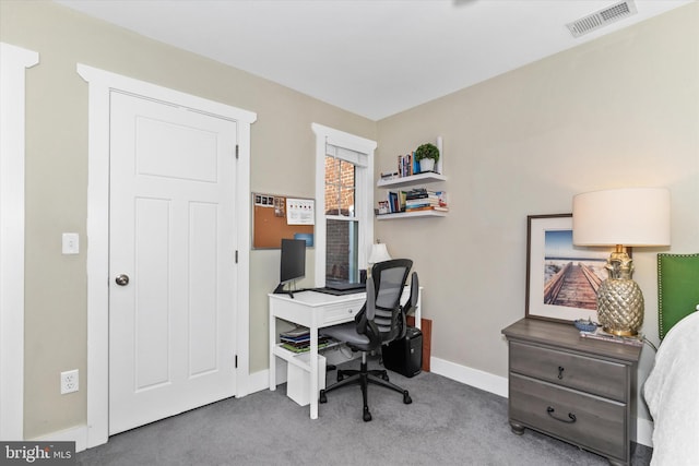 carpeted office featuring visible vents and baseboards