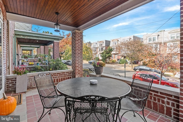 view of patio with outdoor dining area and a residential view