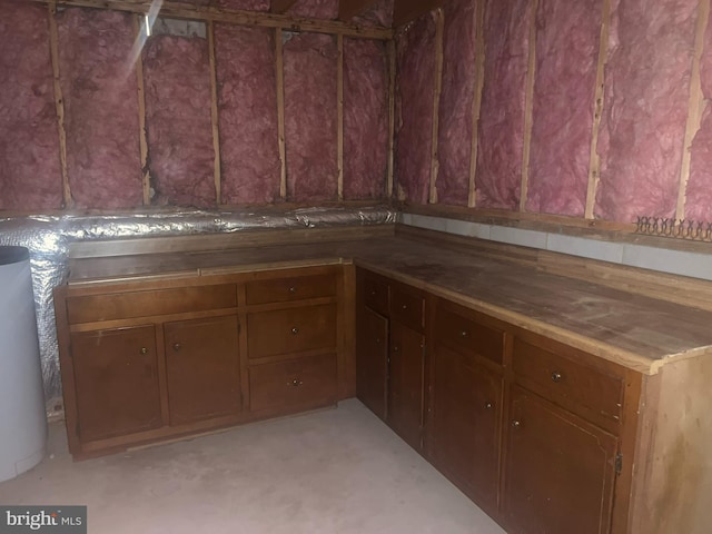 interior space featuring brown cabinetry and water heater