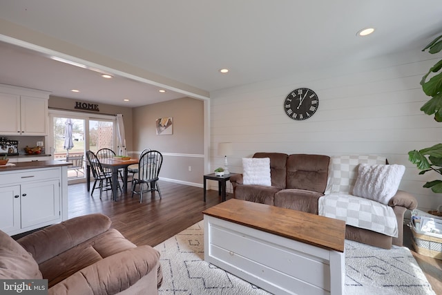 living room with recessed lighting, baseboards, and wood finished floors