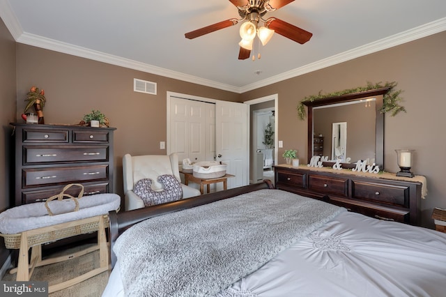 bedroom with a closet, visible vents, ceiling fan, and ornamental molding