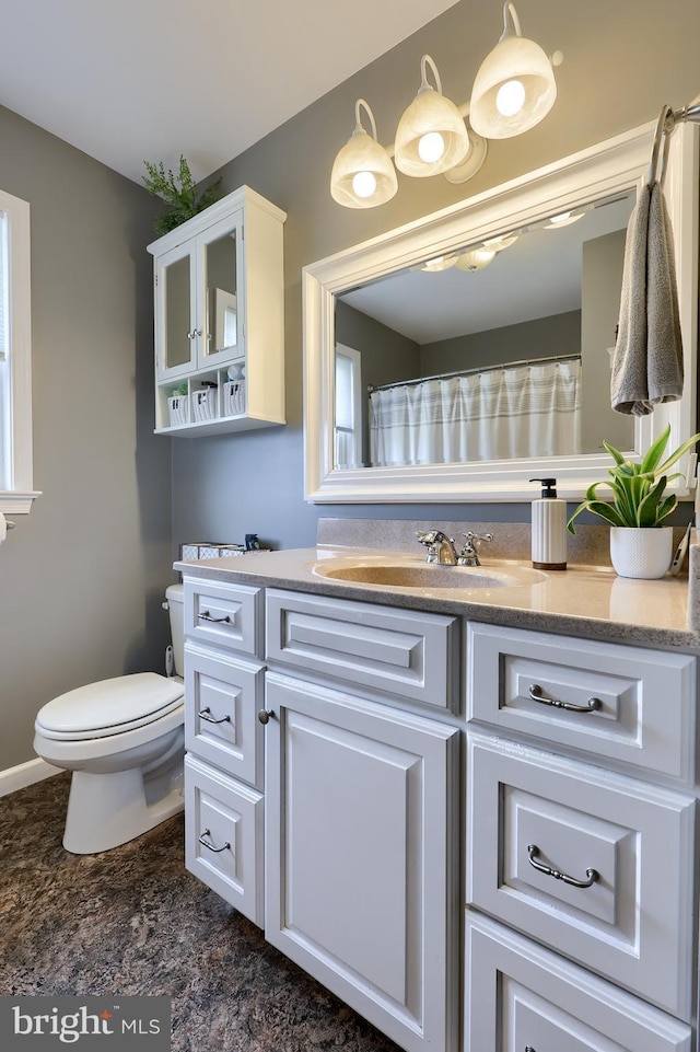 bathroom featuring toilet and vanity