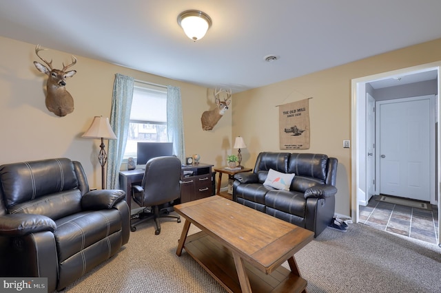 office space with light carpet, visible vents, and baseboards