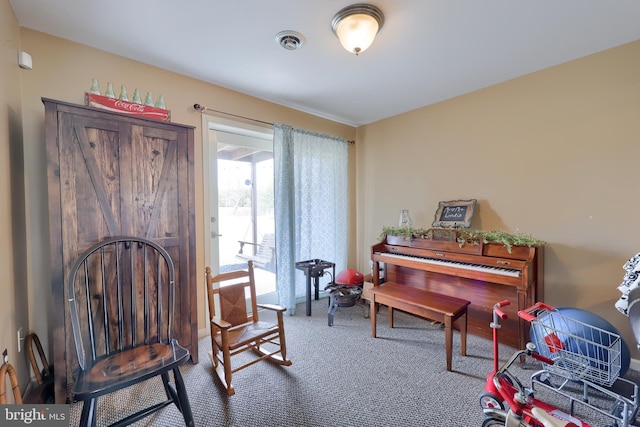 living area with visible vents and carpet flooring