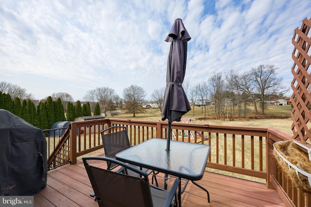 deck with outdoor dining area and a grill