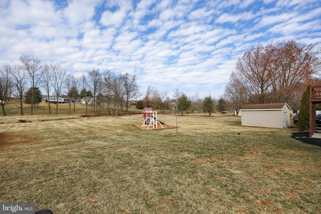 view of yard with a storage unit, a playground, and an outdoor structure