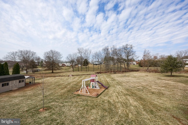 view of yard featuring an outbuilding and a playground