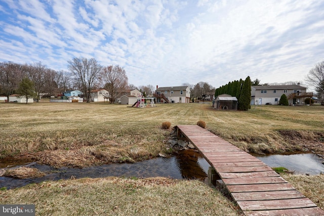 dock area featuring a playground and a yard