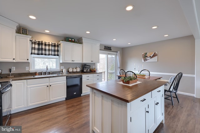 kitchen with dark wood finished floors, recessed lighting, black appliances, wood counters, and a sink