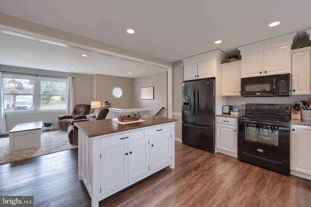 kitchen featuring recessed lighting, white cabinetry, black appliances, and dark wood-type flooring