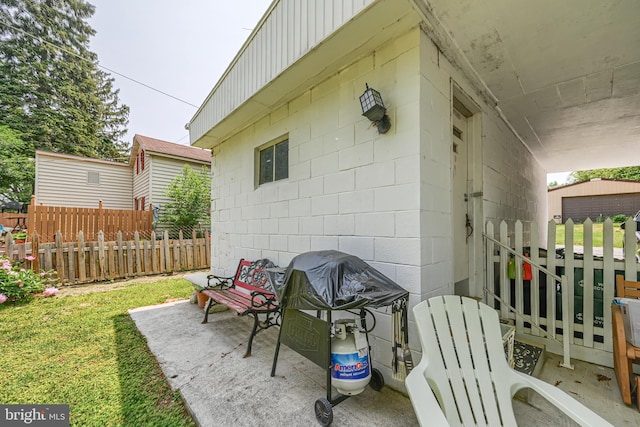 view of patio with area for grilling and fence