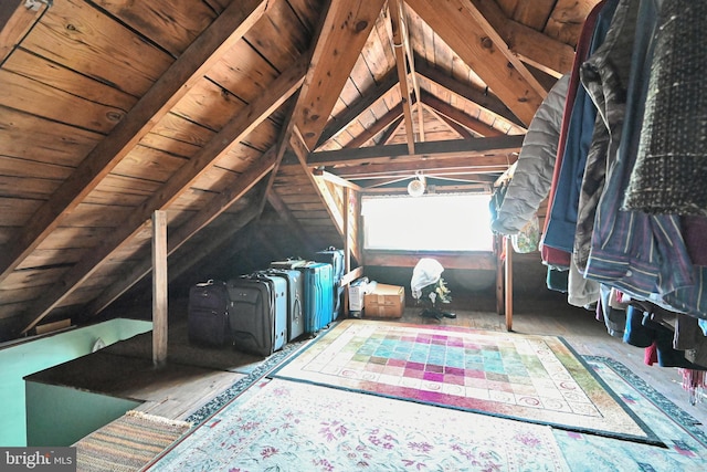 bedroom with lofted ceiling with beams and wooden ceiling