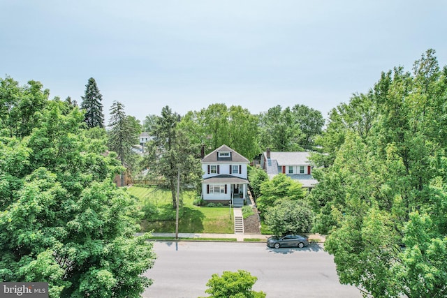 view of front of house with stairway and a front lawn