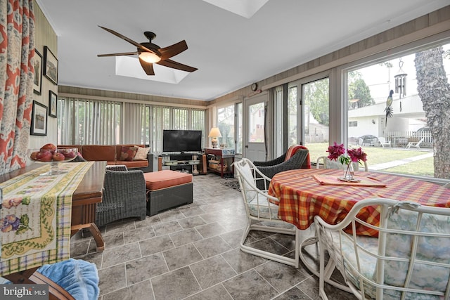 sunroom / solarium featuring ceiling fan