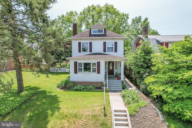 traditional style home with fence, a porch, roof with shingles, a front yard, and a chimney