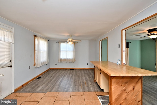 kitchen with tile patterned floors, visible vents, baseboards, and a ceiling fan