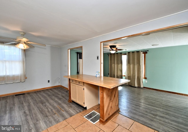 kitchen featuring visible vents, ceiling fan, and wood finished floors