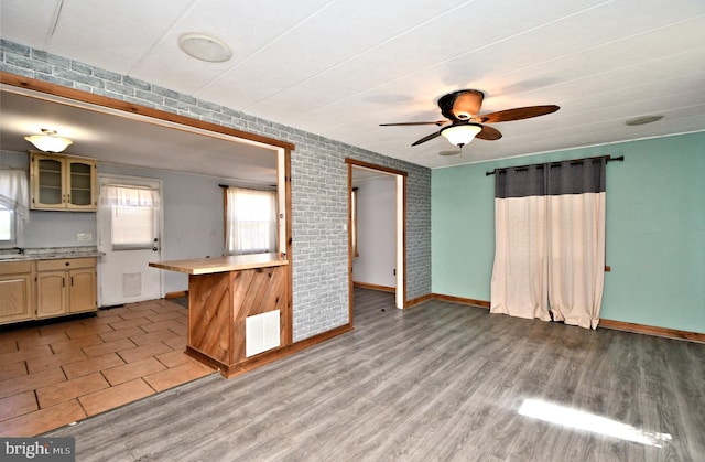 kitchen featuring visible vents, light wood finished floors, a ceiling fan, and light countertops