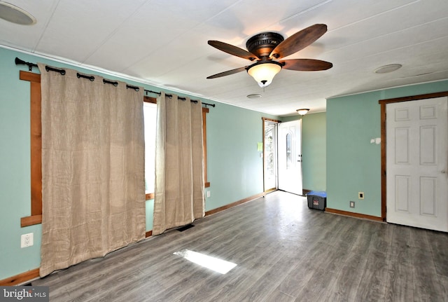 spare room with visible vents, baseboards, a ceiling fan, and wood finished floors