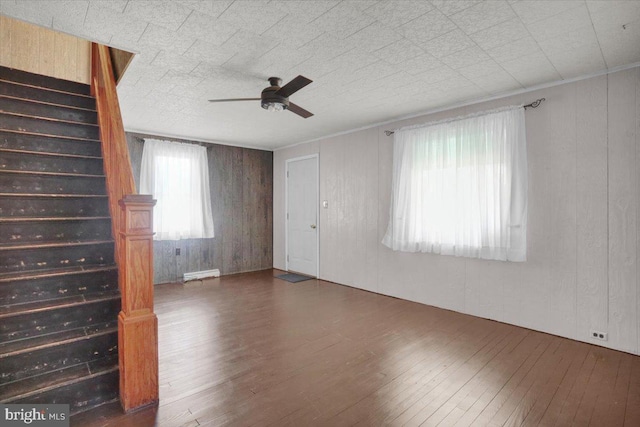 unfurnished living room with wood-type flooring and ceiling fan