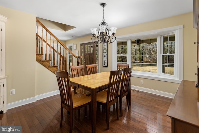 dining space with a chandelier, stairway, baseboards, and dark wood-style flooring