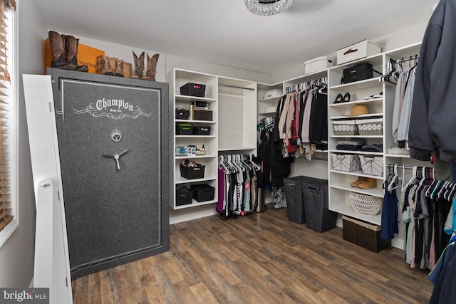 walk in closet with wood finished floors