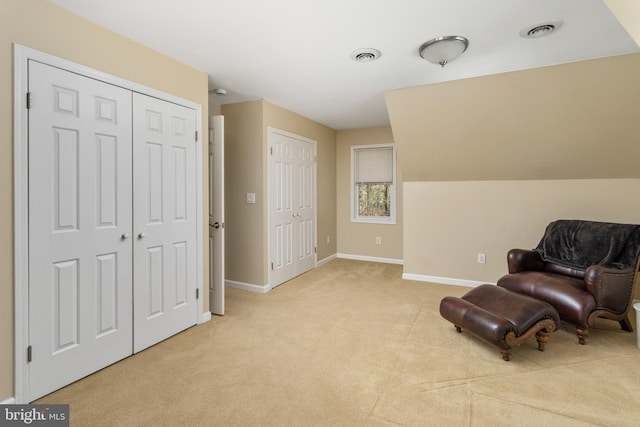 sitting room with visible vents, light carpet, and baseboards