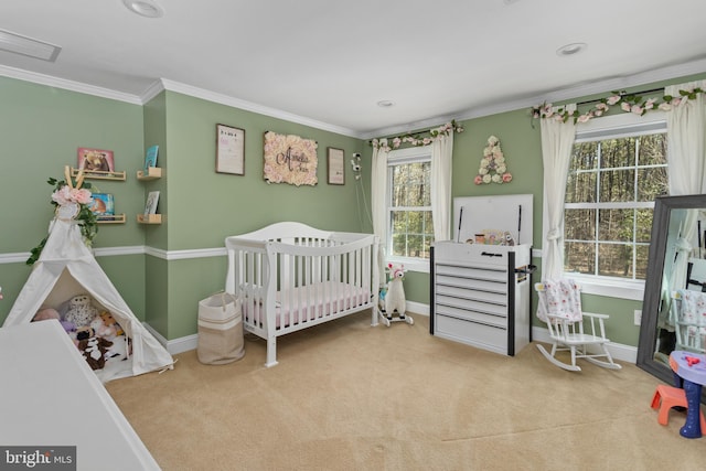 carpeted bedroom featuring baseboards, multiple windows, a nursery area, and ornamental molding