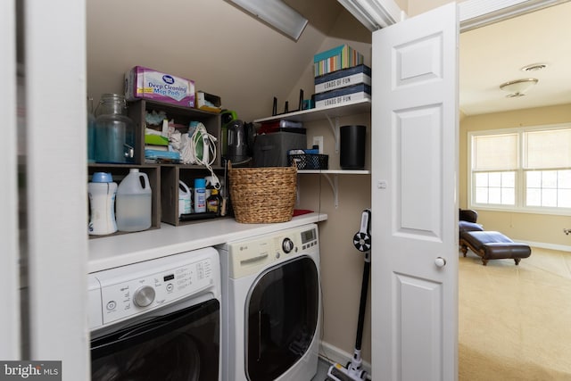 clothes washing area with laundry area, washing machine and dryer, and visible vents