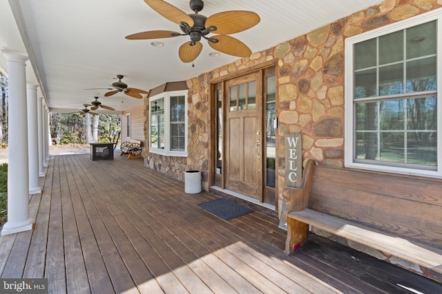 wooden terrace with a porch and a ceiling fan