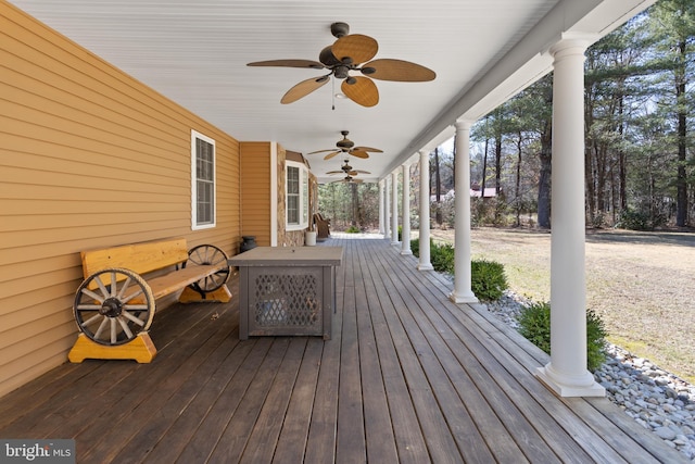 wooden deck with a ceiling fan