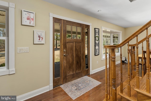 entrance foyer with baseboards and dark wood-style flooring