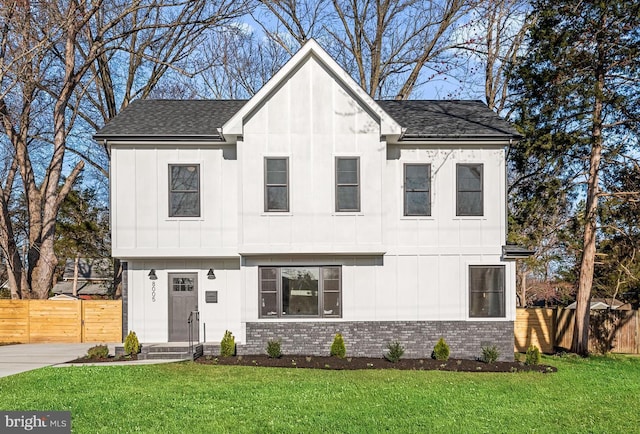 modern farmhouse style home featuring brick siding, board and batten siding, and fence