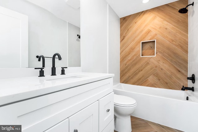 bathroom featuring bathing tub / shower combination, toilet, and vanity