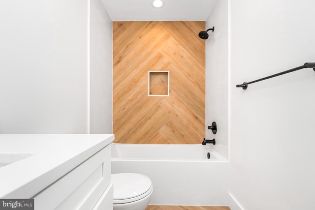 bathroom featuring tub / shower combination, toilet, and vanity