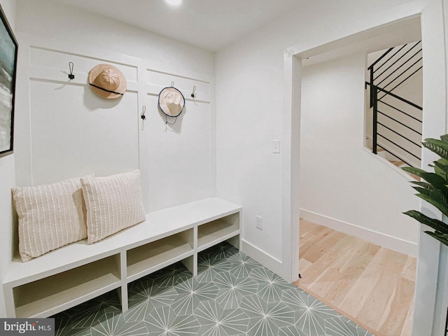 mudroom with wood finished floors and baseboards