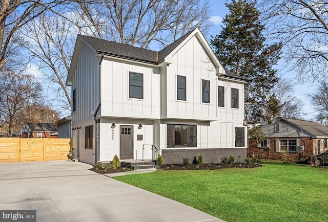 modern farmhouse style home with brick siding, board and batten siding, and fence