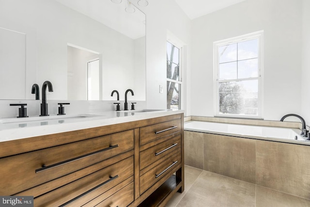 full bath featuring double vanity, a bath, and a sink