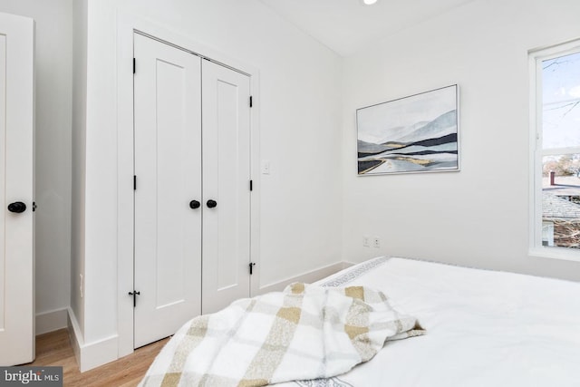 bedroom with a closet and light wood finished floors