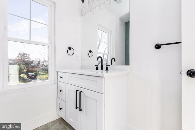 bathroom featuring tile patterned floors, a healthy amount of sunlight, and vanity