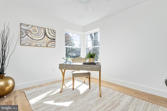 office area featuring baseboards and wood finished floors