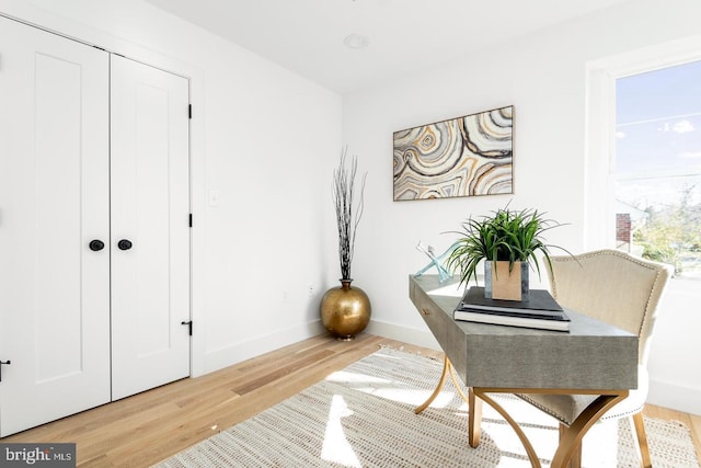 sitting room featuring baseboards and wood finished floors