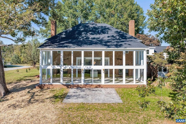 view of outbuilding featuring a sunroom