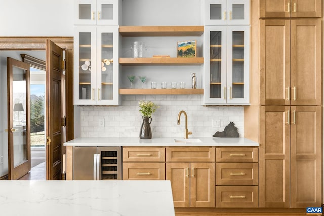 bar with wine cooler, tasteful backsplash, indoor wet bar, and a sink