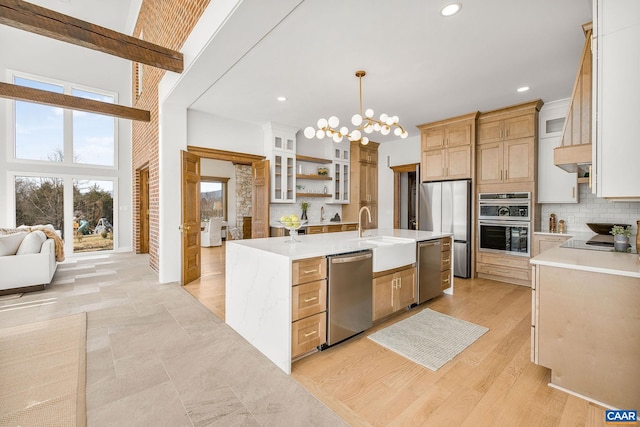 kitchen featuring a sink, decorative backsplash, appliances with stainless steel finishes, and light countertops