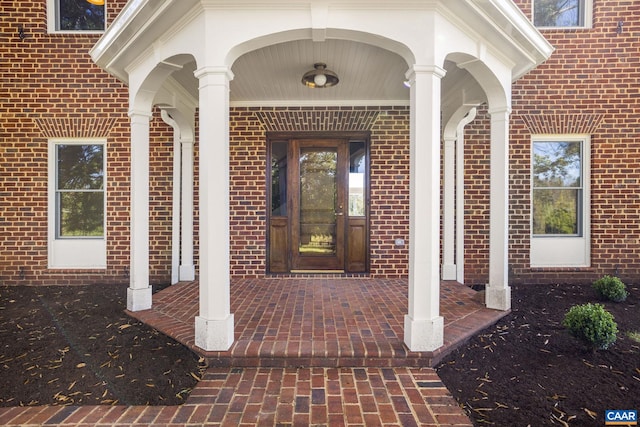 property entrance featuring brick siding