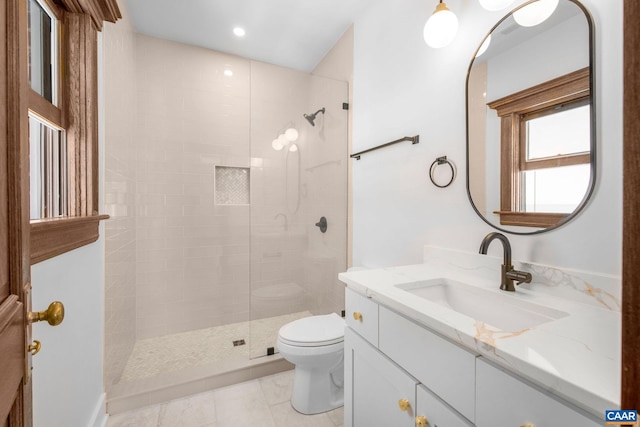 full bathroom with vanity, toilet, tile patterned flooring, and tiled shower